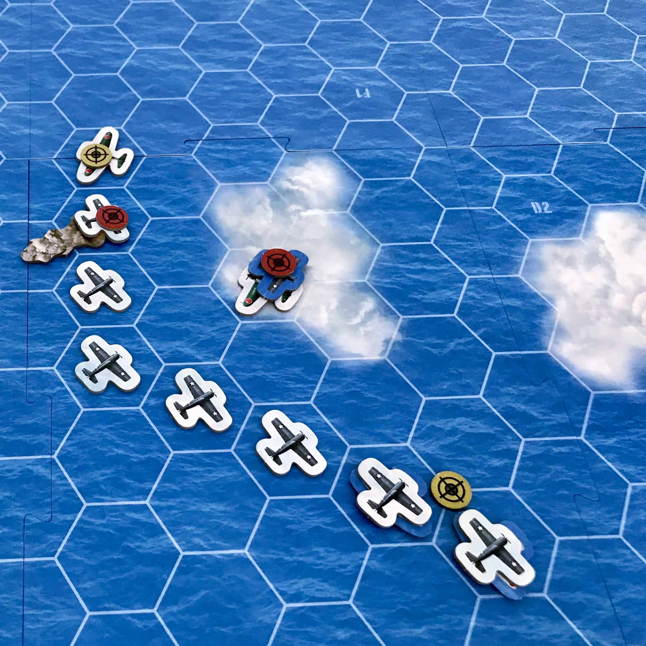 Lähikuva pelilaudasta, jossa Wildcat-laivue uhkaa pilveen paennutta japanilaispommikonetta