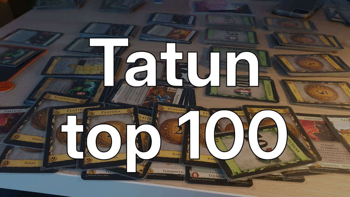 Tatun top 100 -teksti, taustallaan Dominionin kortteja