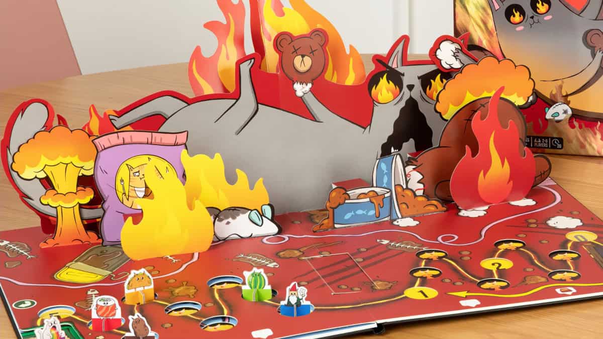 Exploding Kittens: The Board Game -pelin pelilaudan flipattu p uoli, jossa on liekkien keskellä raivoava 3D-popup-kissa.