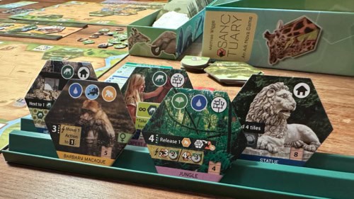 Sanctuaryn laattateline, jossa on viisi isoa heksalaattaa. Etualalla on magotti ja viidakko, taustalla pari kasvissyöjäkorttia (rakennus ja asiantuntijaprojekti) ja patsas.