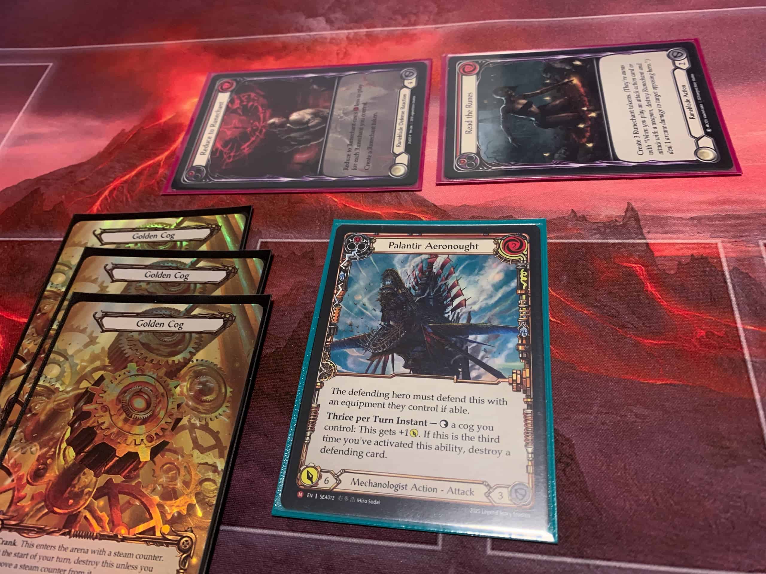 Palantir Aeronought -kortti, kolme Golden Cog -korttia ja kaksi puolustuskorttia.