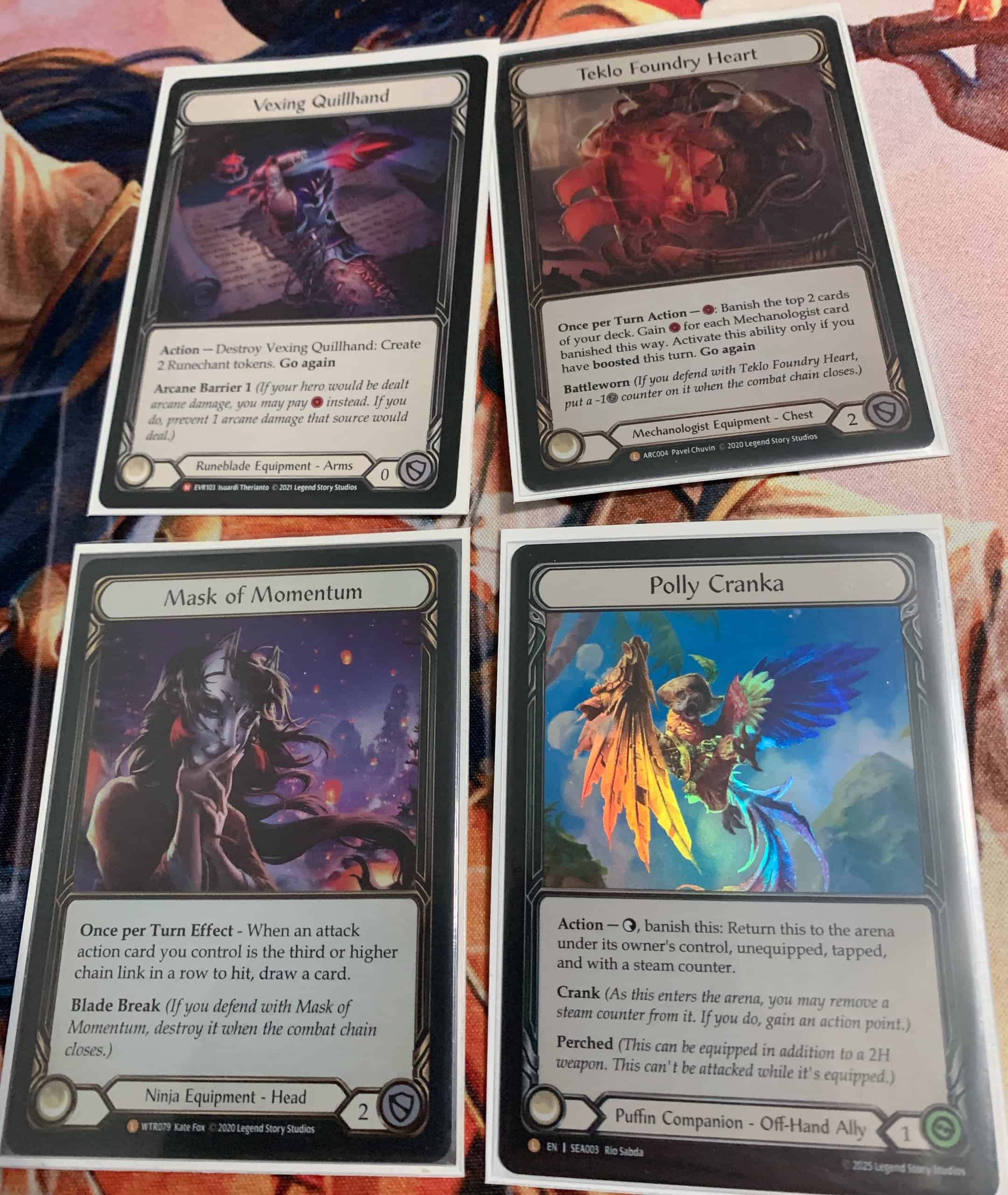 Neljä varustekorttia: Vexing Quillhand, Teklo Foundry Heart, Mask of Momentum ja Polly Cranka.