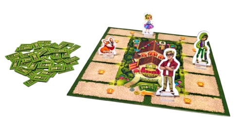 My Own Toy Shopin pelilauta, jossa on neljä pahvihahmoa standeissa: aikuinen, kaksi lapsihahmoa ja koirahahmo. Vieressä on läjä pahvisia rahatokeneita.