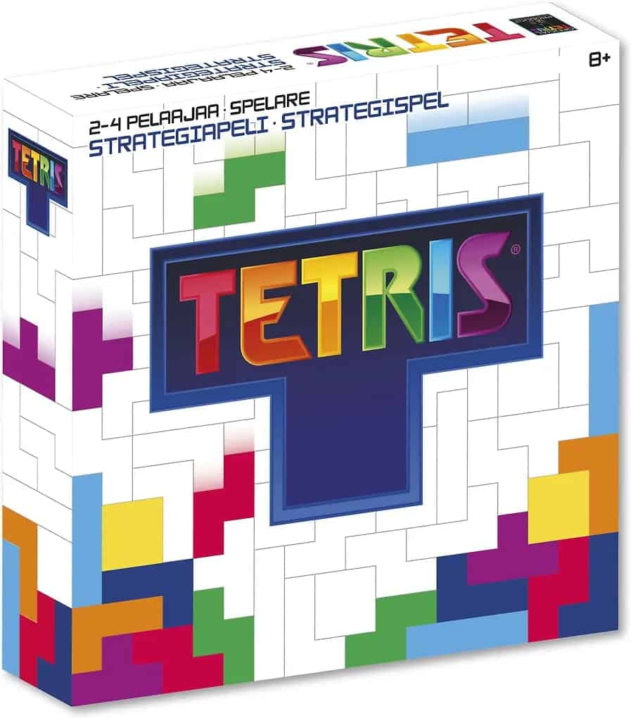Tetris-pelin valkoisessa laatikossa on alareunassa tetriminoista muodostuvia kasoja ja keskellä iso sininen T-pala, jonka sisällä on pelin nimi.